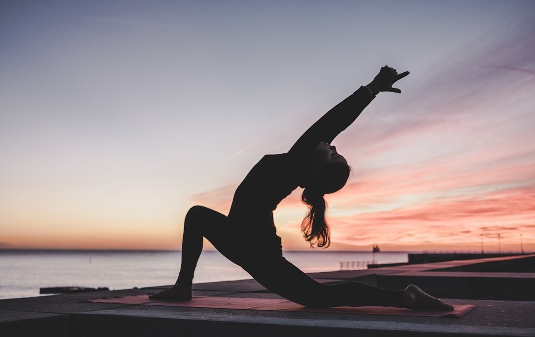 A serene scene depicting a person practicing yoga in a natural setting, symbolizing a balanced and healthy lifestyle.