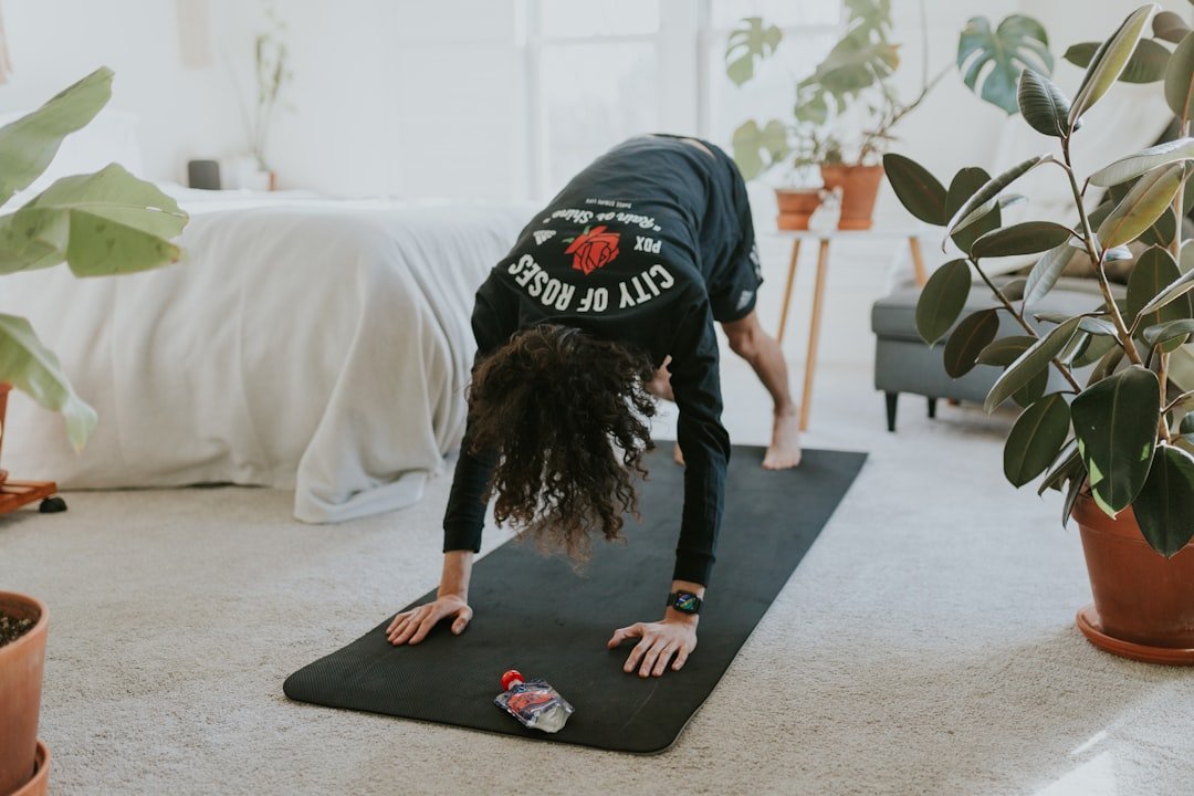 A person exercising at home with minimal equipment, showcasing a simple workout routine in a cozy living space.